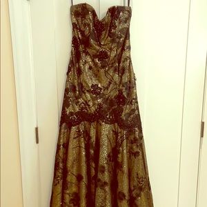 Strapless black and gold ball gown with train.